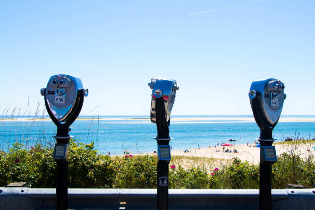 Lookout at Lighthouse Beach in Chatham with bright blue ocean water and a blue sky