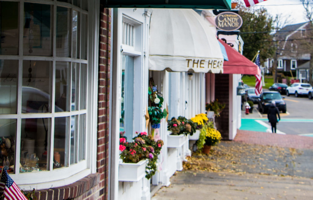 Storefronts and the sidewalk on Main Street in Chatham, MA
