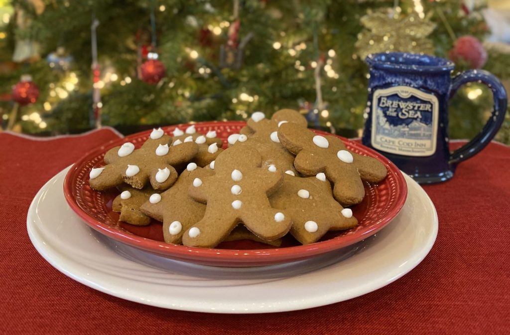 Gingerbread cookies on a plate in front of a Christmas tree