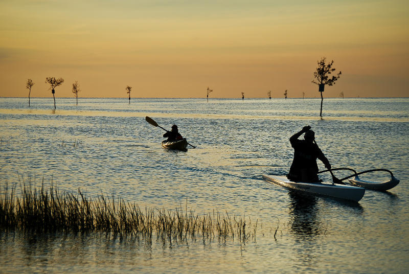 Two people kayaking by Rock Harbor in Orleans at sunset | Brewster By the Sea Cape Cod Inn | Brewster, MA